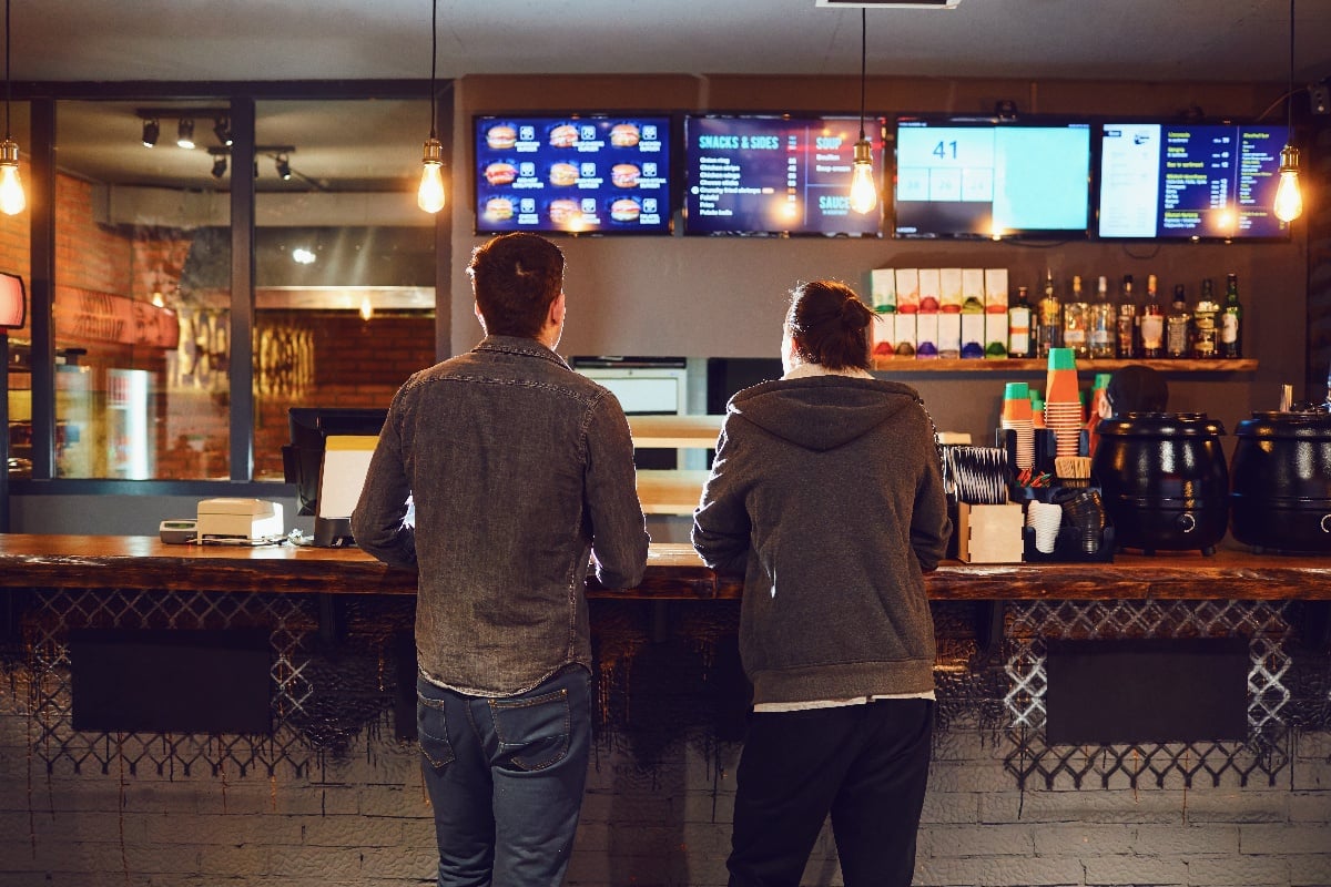 men_ordering_at_restaurant_counter